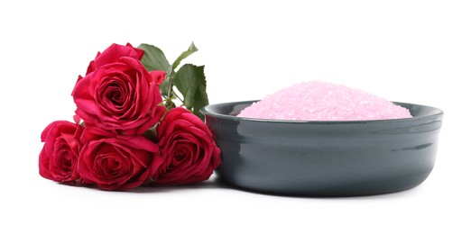 Photo of Pink sea salt in bowl and roses isolated on white
