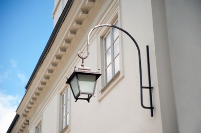 Photo of Vintage street lamp on wall of building outdoors, low angle view