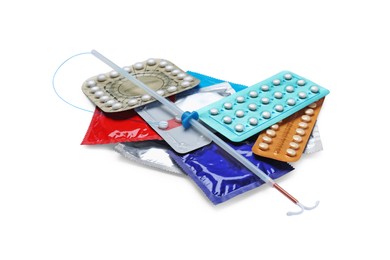Photo of Contraceptive pills, condoms and intrauterine device isolated on white. Different birth control methods