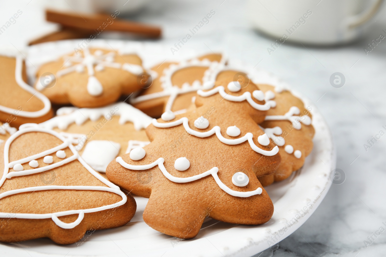 Photo of Plate with tasty homemade Christmas cookies on table, closeup