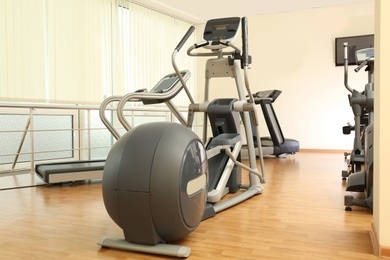 Photo of Elliptical trainer in gym. Modern sport equipment