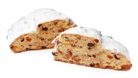Photo of Cut delicious Stollen sprinkled with powdered sugar isolated on white