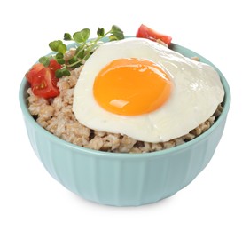 Tasty boiled oatmeal with fried egg, tomato and microgreens isolated on white