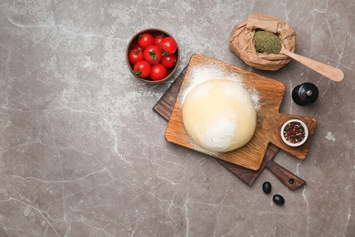 Photo of Dough and ingredients for pizza on table, top view
