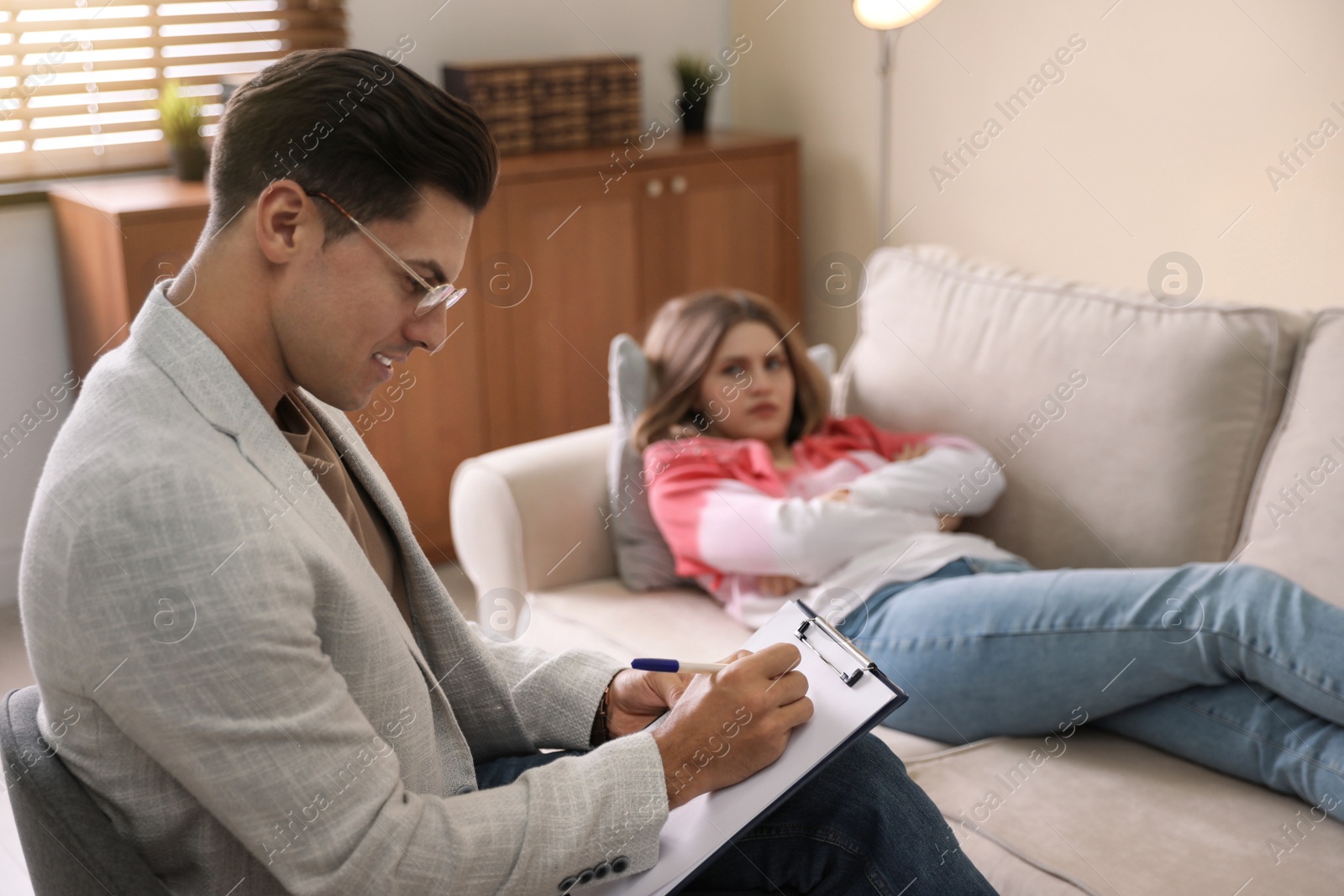 Photo of Professional psychotherapist working with patient in office