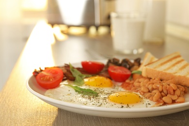 Photo of Tasty breakfast with fried eggs on wooden table, closeup