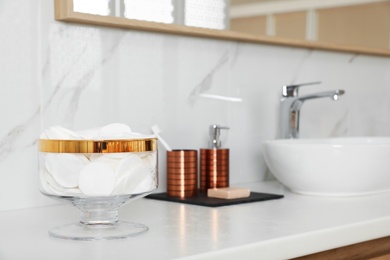 Jar with cotton pads on bathroom countertop