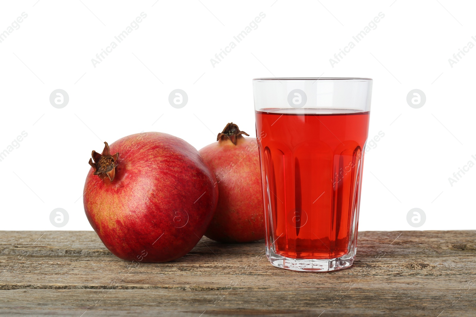 Photo of Refreshing pomegranate juice in glass and fruits on wooden table against white background