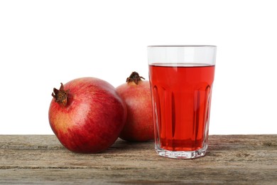 Photo of Refreshing pomegranate juice in glass and fruits on wooden table against white background