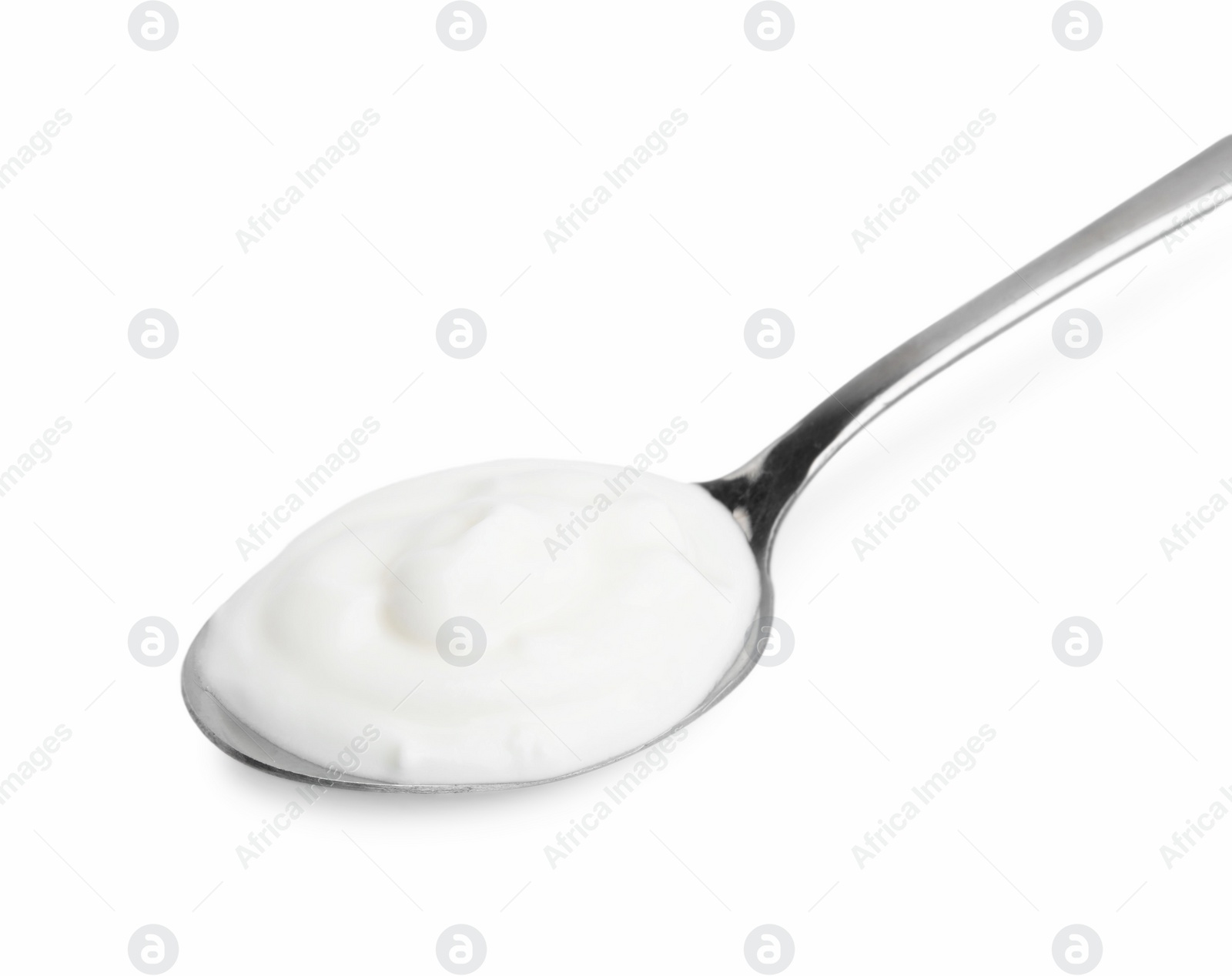 Photo of Delicious natural yogurt in spoon isolated on white