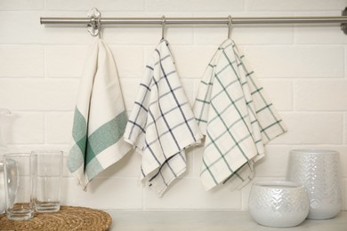 Photo of Different clean towels hanging on rack in kitchen