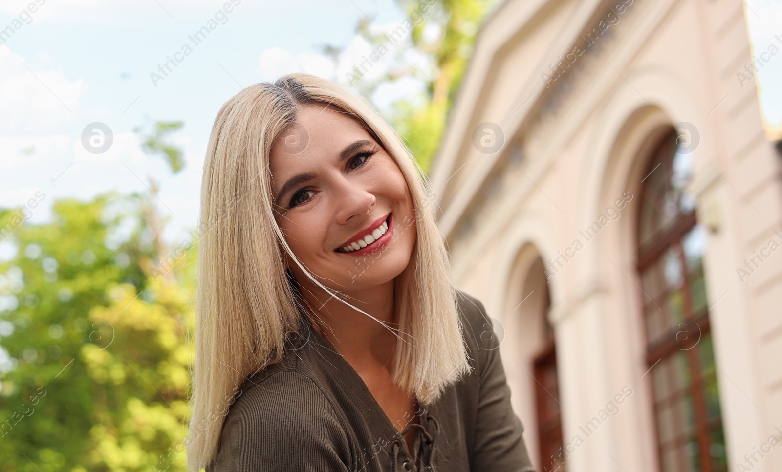 Photo of Portrait of beautiful woman on city street, space for text