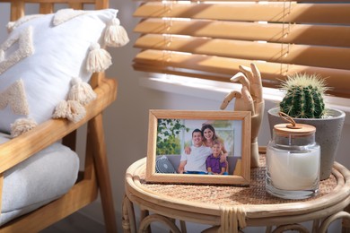 Photo of Frame with photo of lovely family on table indoors