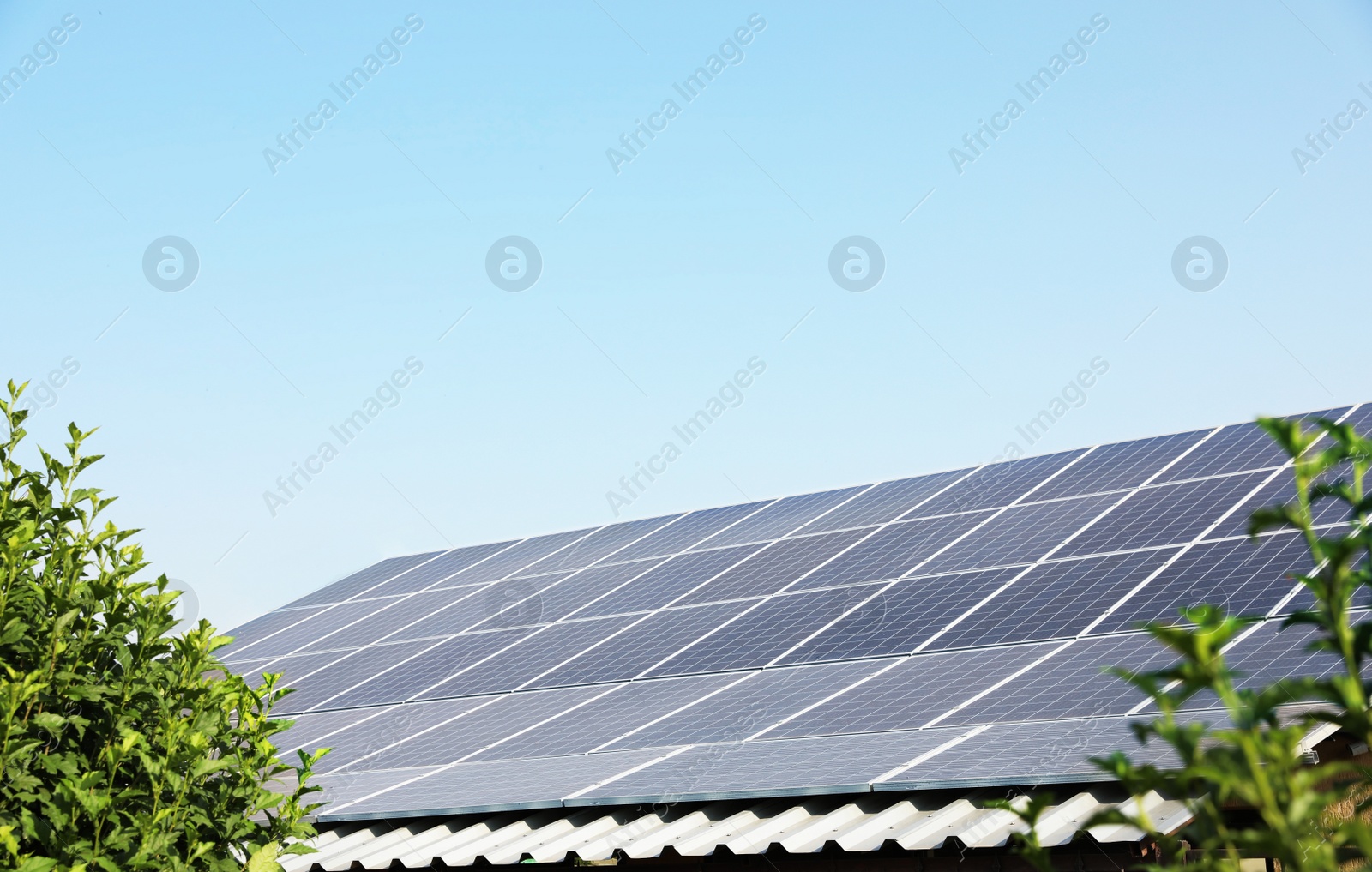 Photo of House with installed solar panels on roof. Alternative energy source