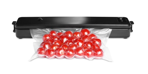 Photo of Sealer for vacuum packing with plastic bag of cherry tomatoes on white background