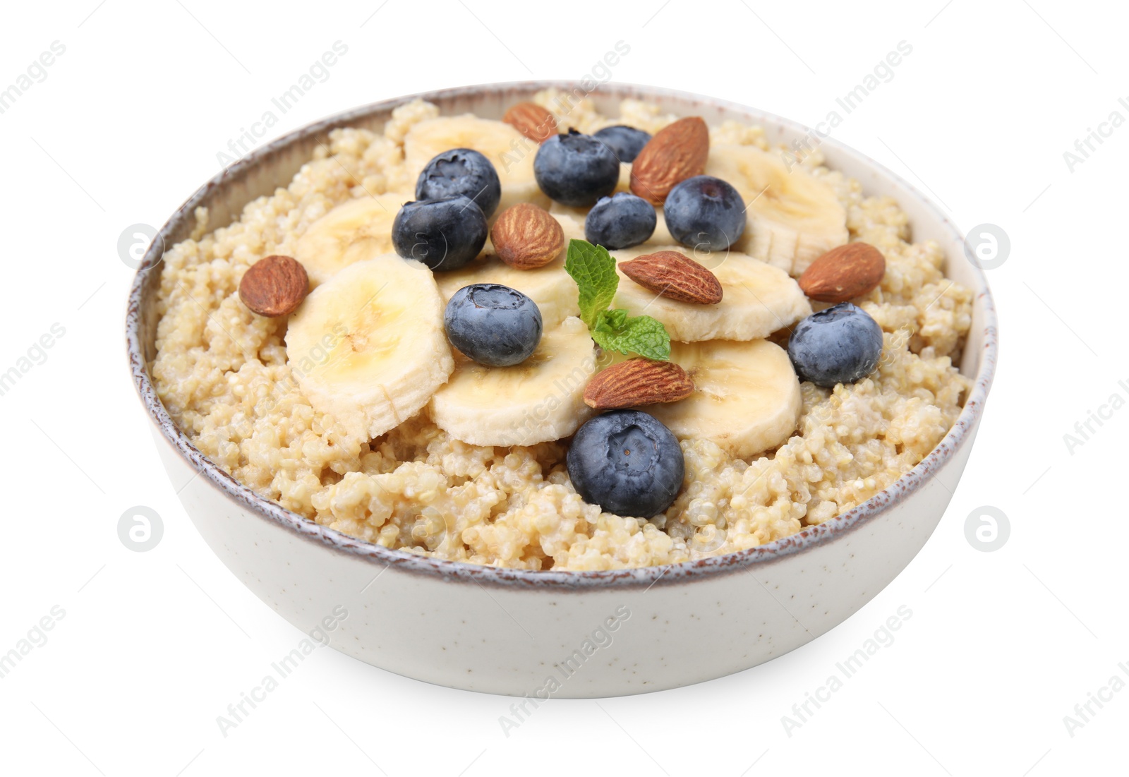 Photo of Bowl of delicious cooked quinoa with almonds, bananas and blueberries isolated on white