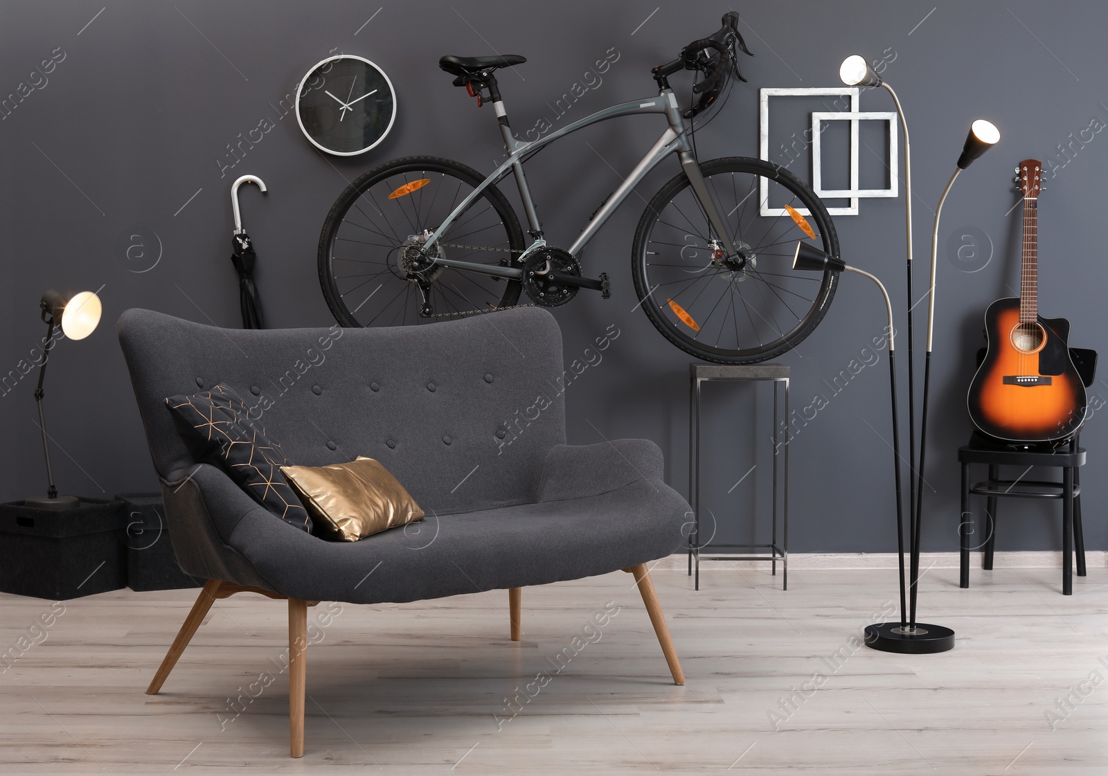 Photo of Stylish room interior with bicycle and sofa