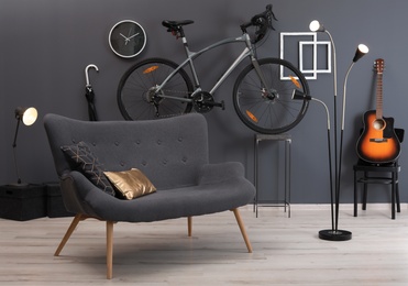 Photo of Stylish room interior with bicycle and sofa