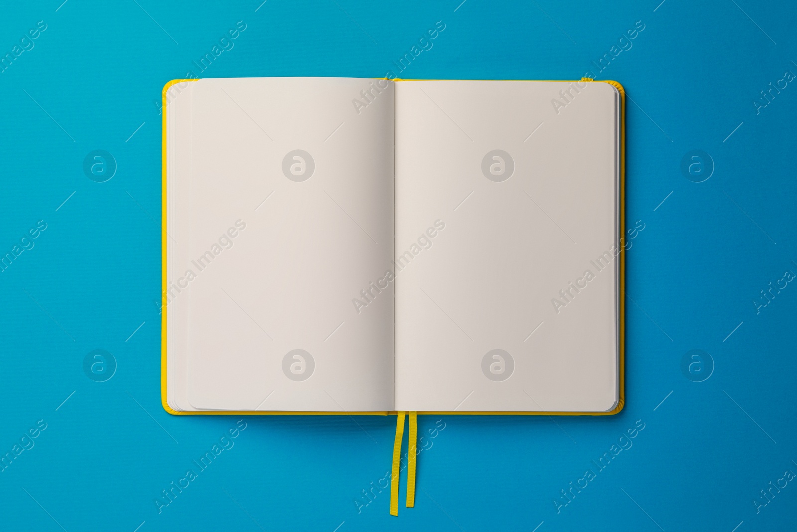 Photo of Blank notebook on light blue background, top view