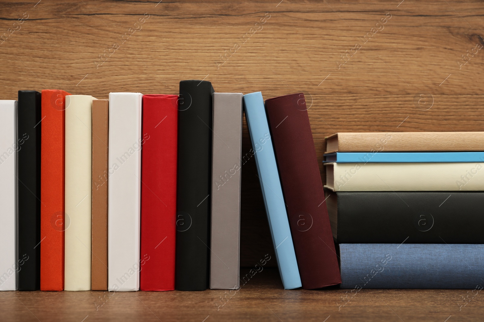 Photo of Many different hardcover books on wooden table