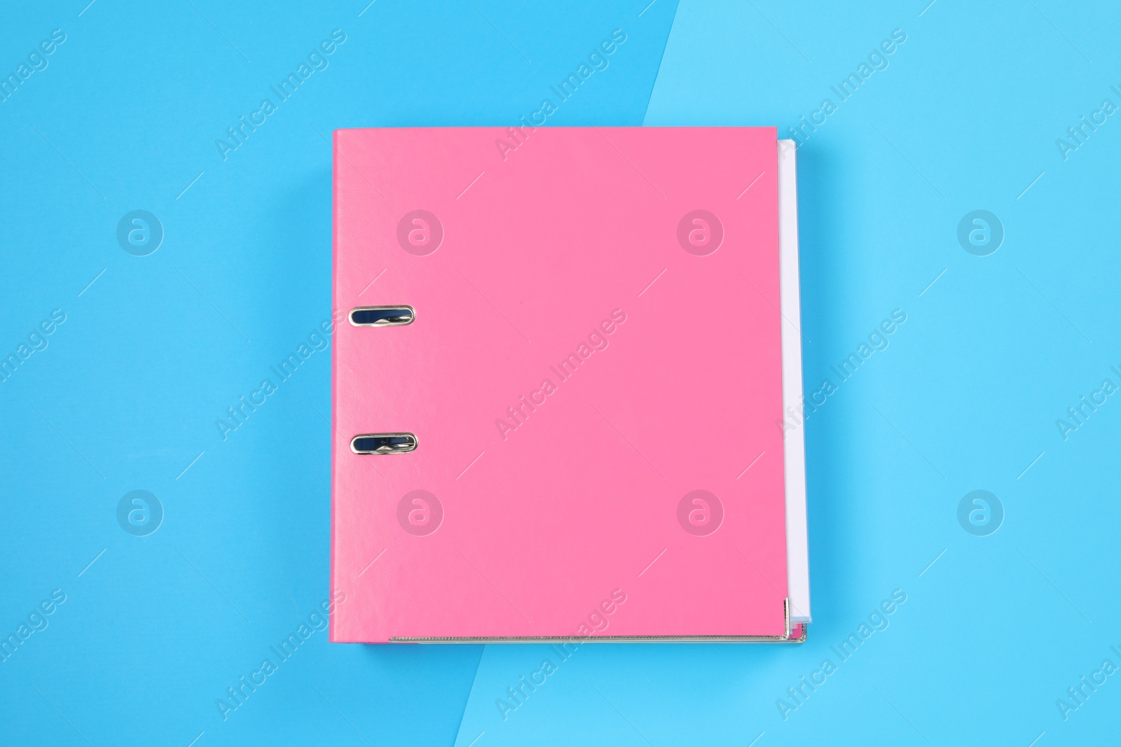Photo of One office folder on light blue background, top view