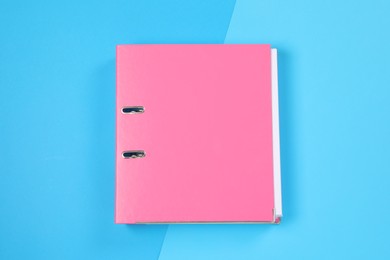 Photo of One office folder on light blue background, top view