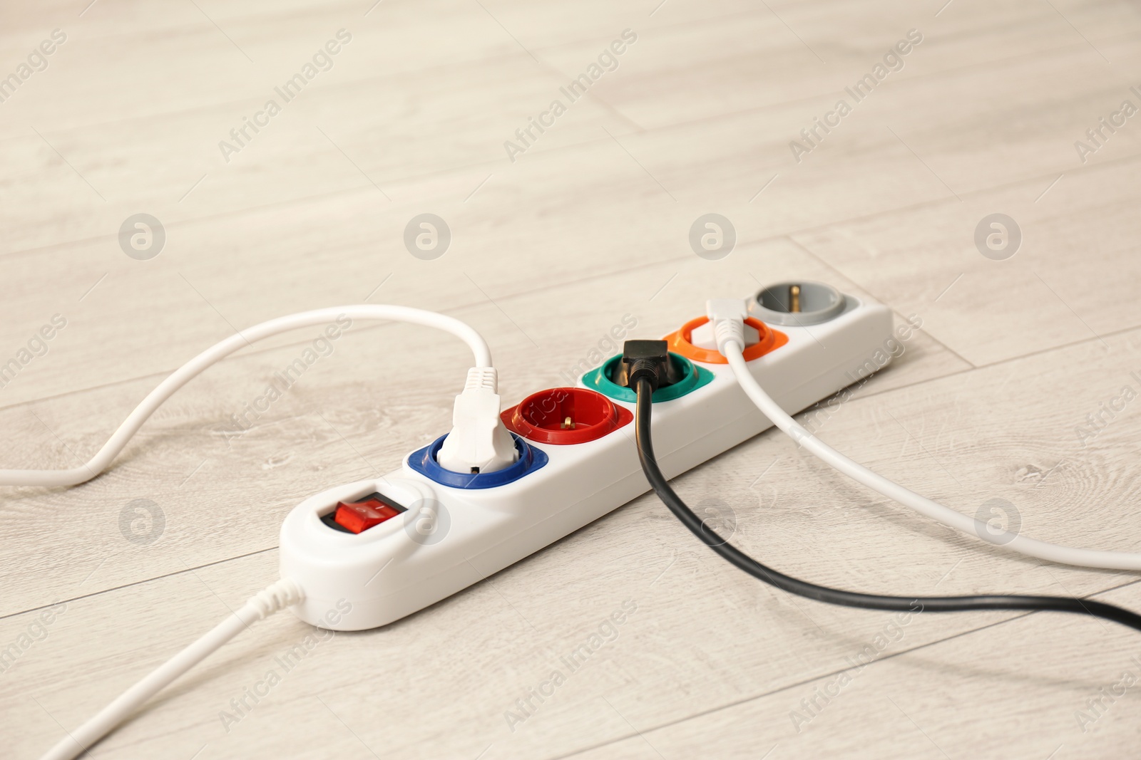 Photo of Extension cord on floor. Electrician's professional equipment