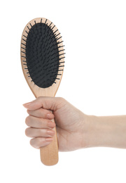 Woman holding wooden hair brush on white background, closeup