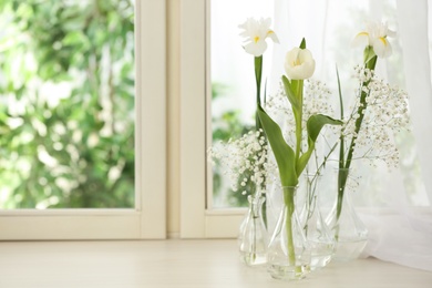 Beautiful fresh flowers on window sill indoors. Space for text