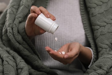 Photo of Woman pouring antidepressants from bottle, closeup view