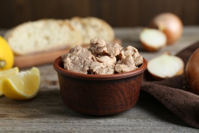 Photo of Bowl of tasty cod liver on wooden table, closeup