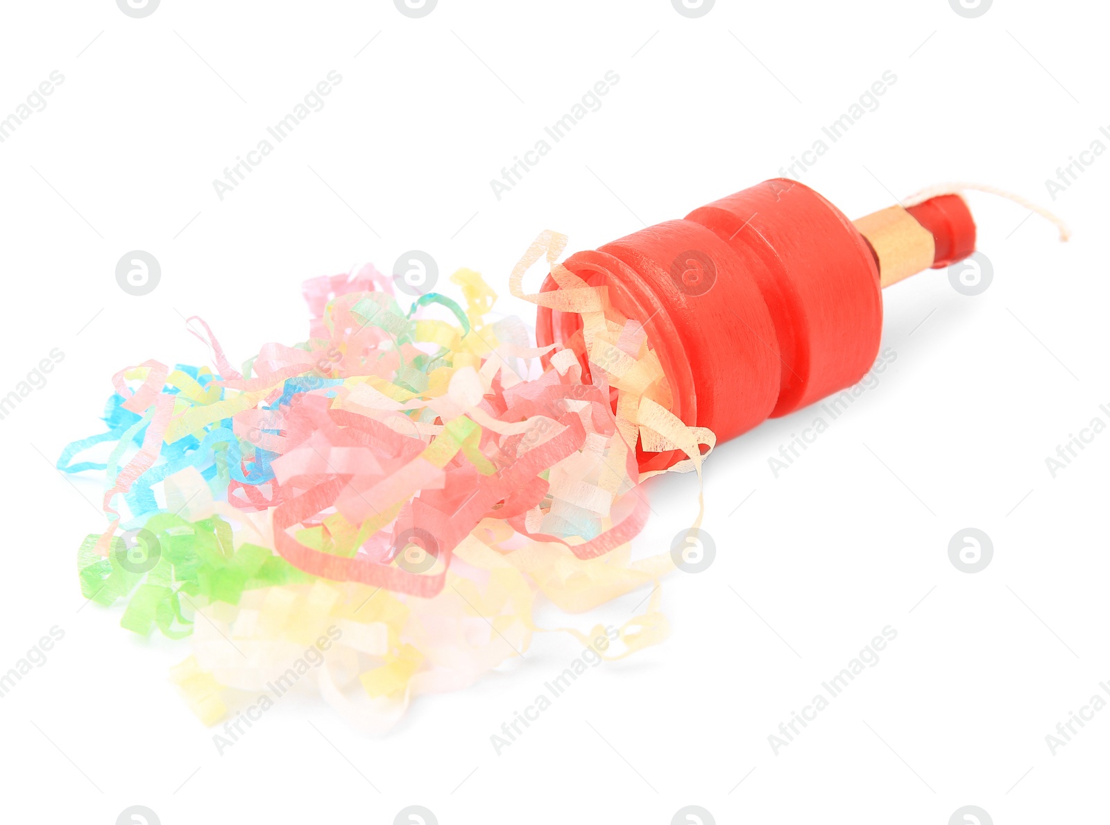 Photo of Colorful streamers with red party cracker isolated on white