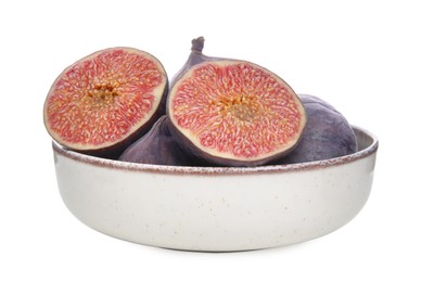 Whole and cut fresh purple figs in bowl isolated on white