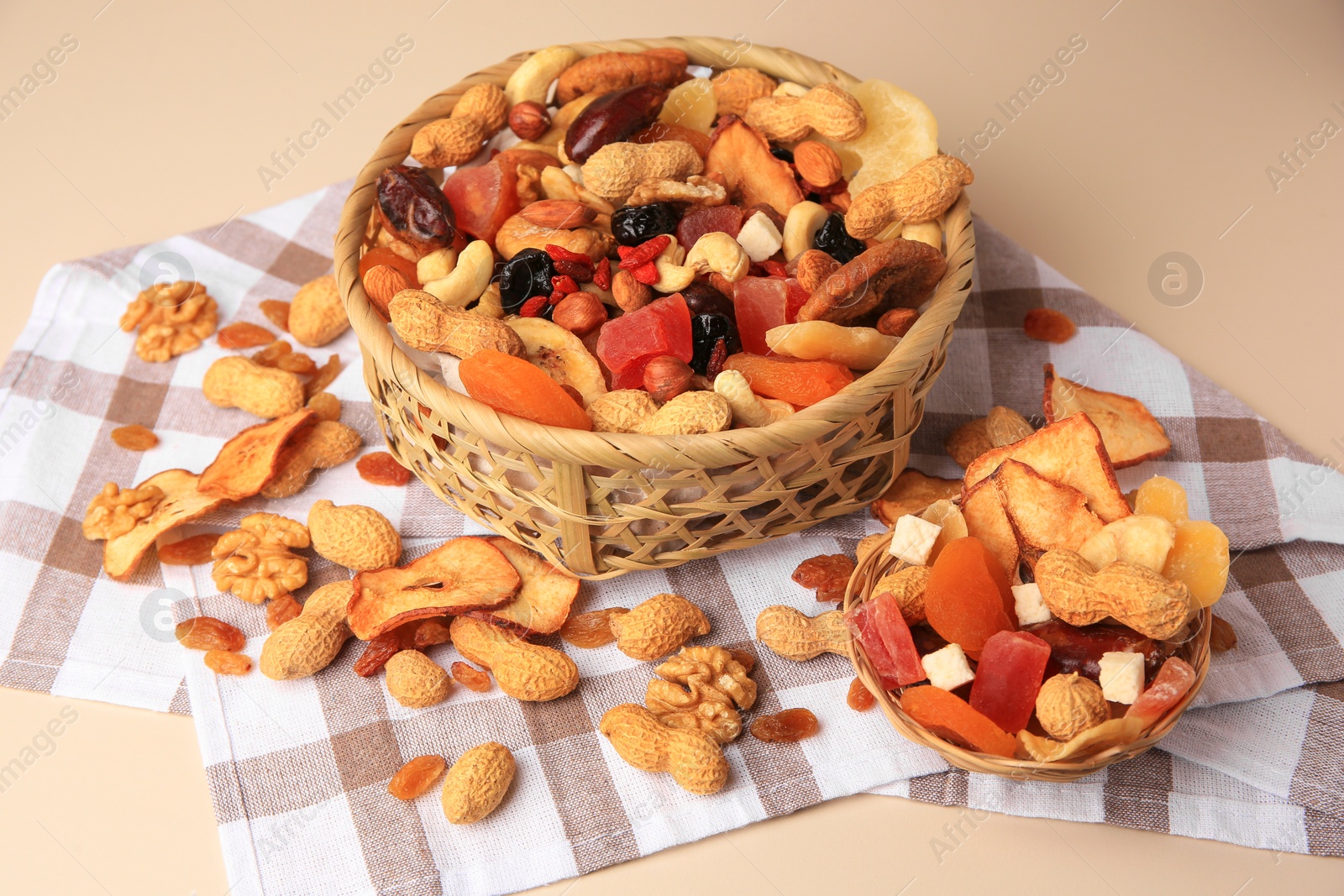 Photo of Mixed dried fruits and nuts on beige background