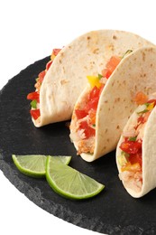 Delicious tacos with vegetables and slices of lime isolated on white