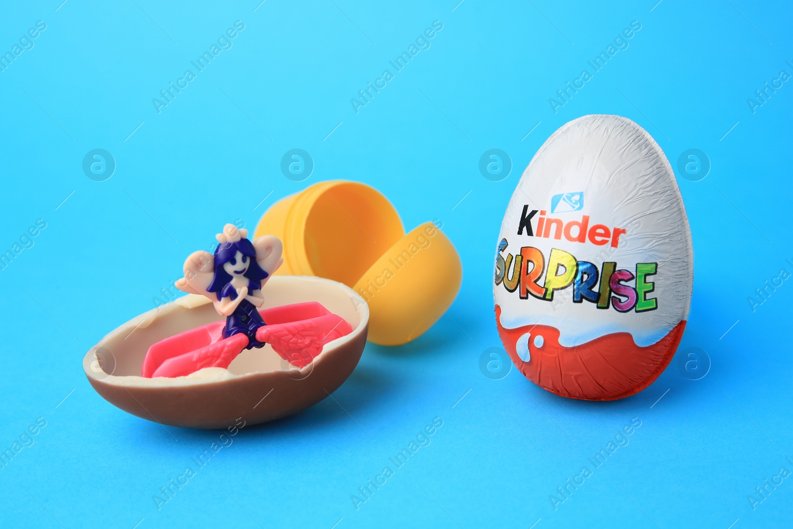 Photo of Slynchev Bryag, Bulgaria - May 25, 2023: Kinder Surprise Eggs, plastic capsule and toy on light blue background