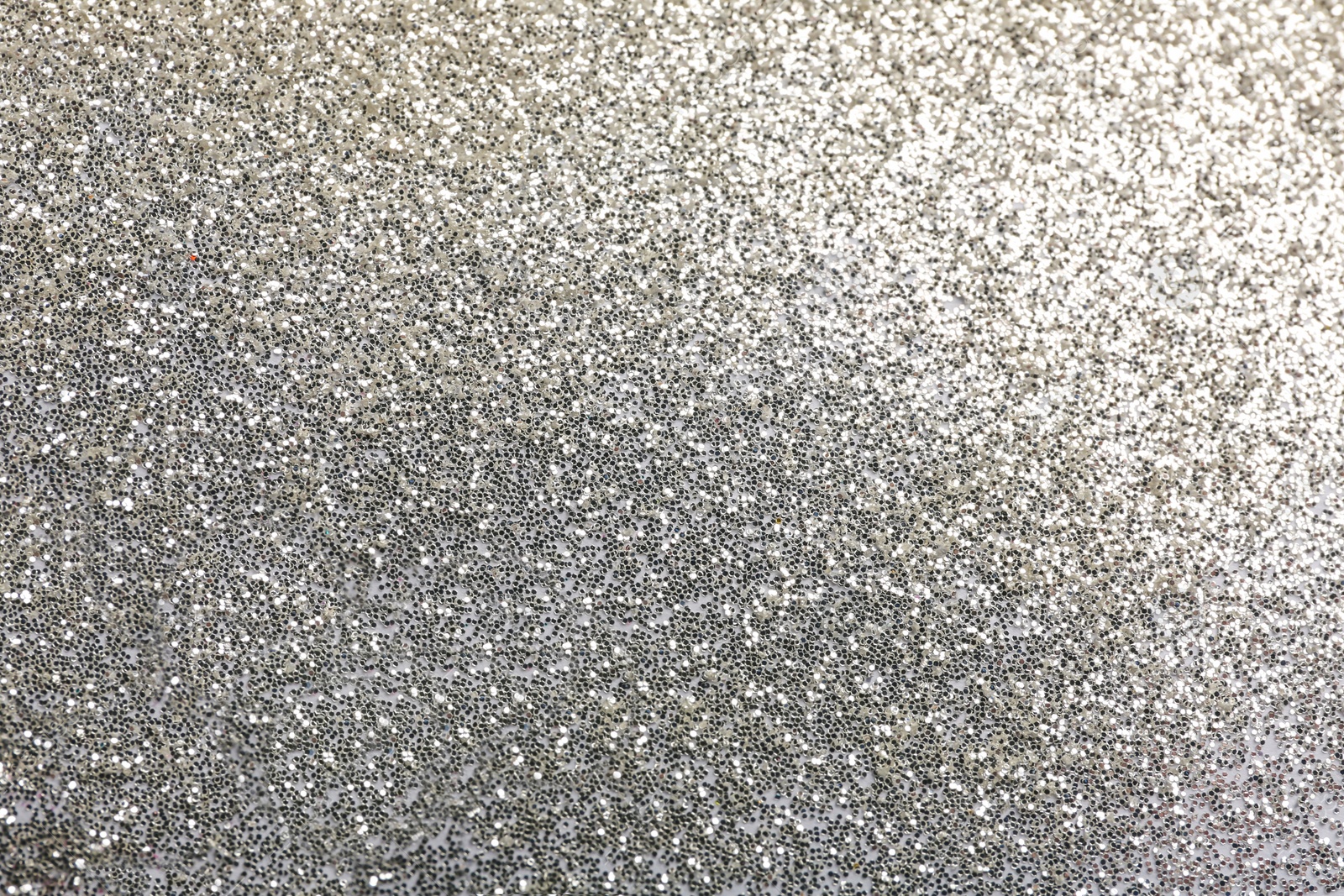 Photo of Closeup view of sparkling silver glitter background