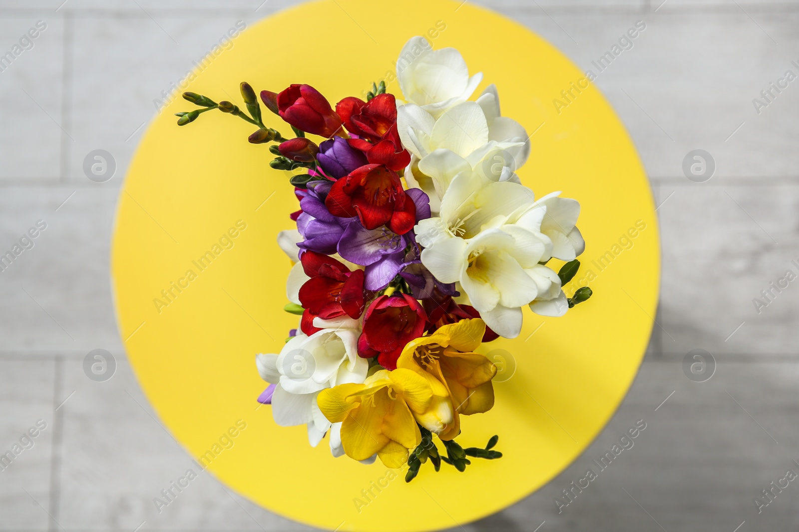 Photo of Beautiful freesia bouquet on table