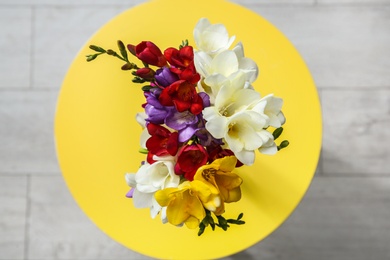 Photo of Beautiful freesia bouquet on table