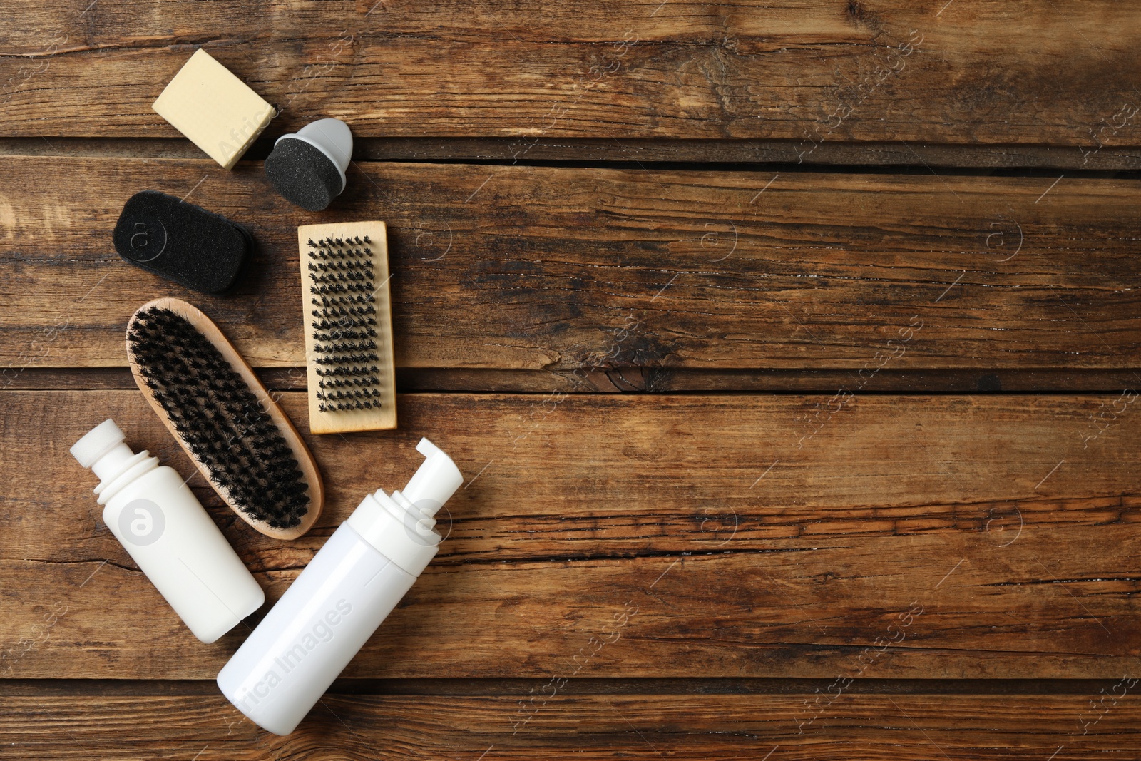 Photo of Flat lay composition with shoe care accessories on wooden background, space for text