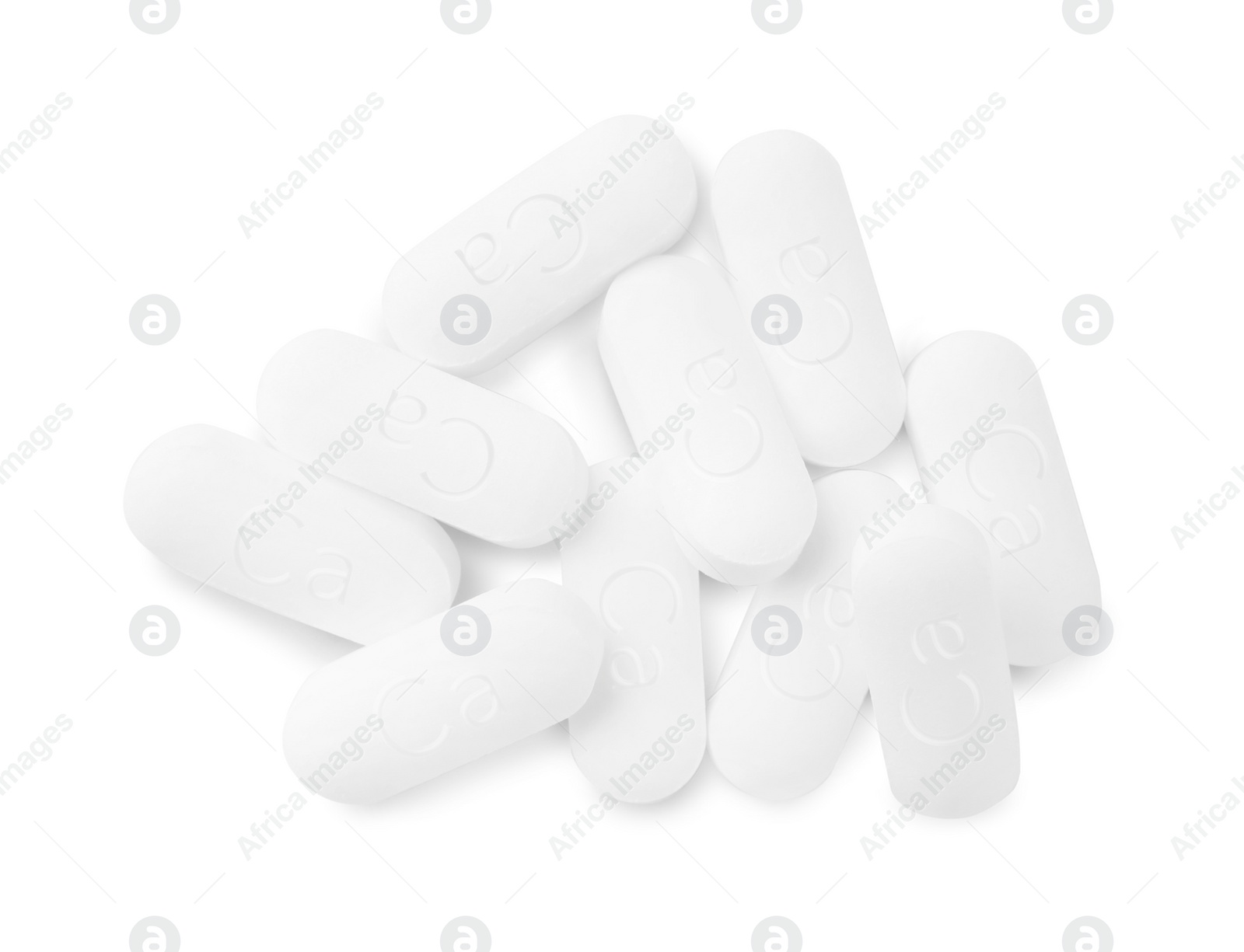 Photo of Pile of calcium supplement pills on white background, flat lay