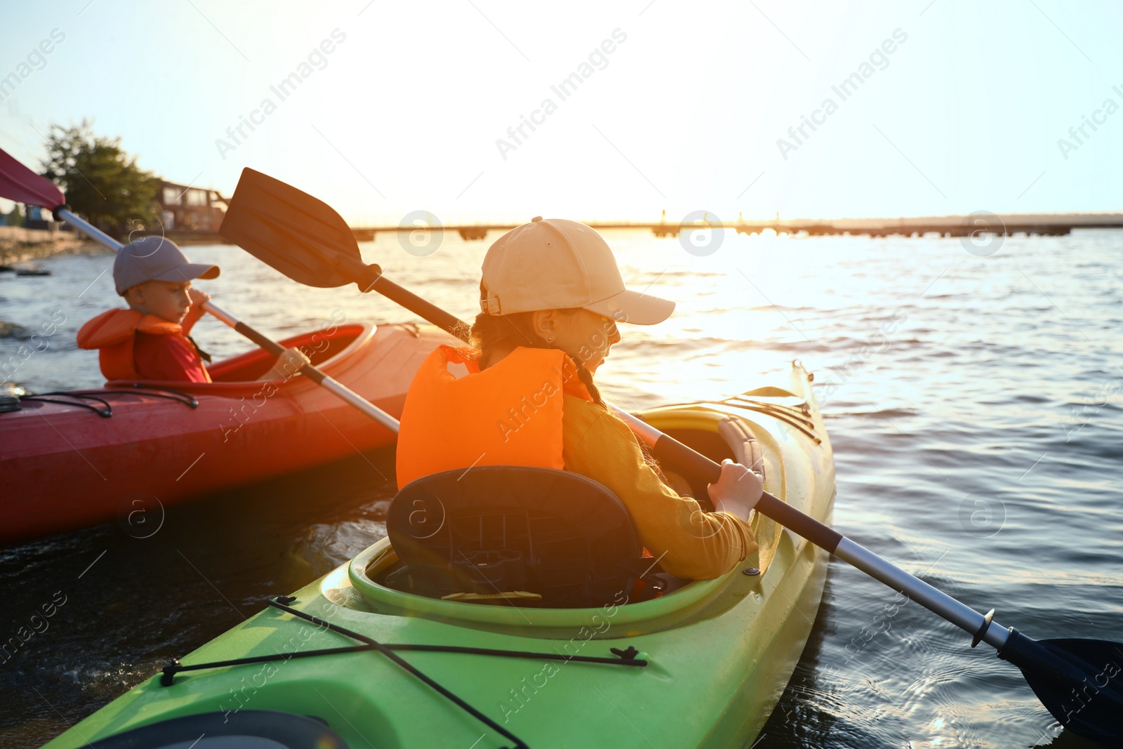 Photo of Little children kayaking on river. Summer camp activity