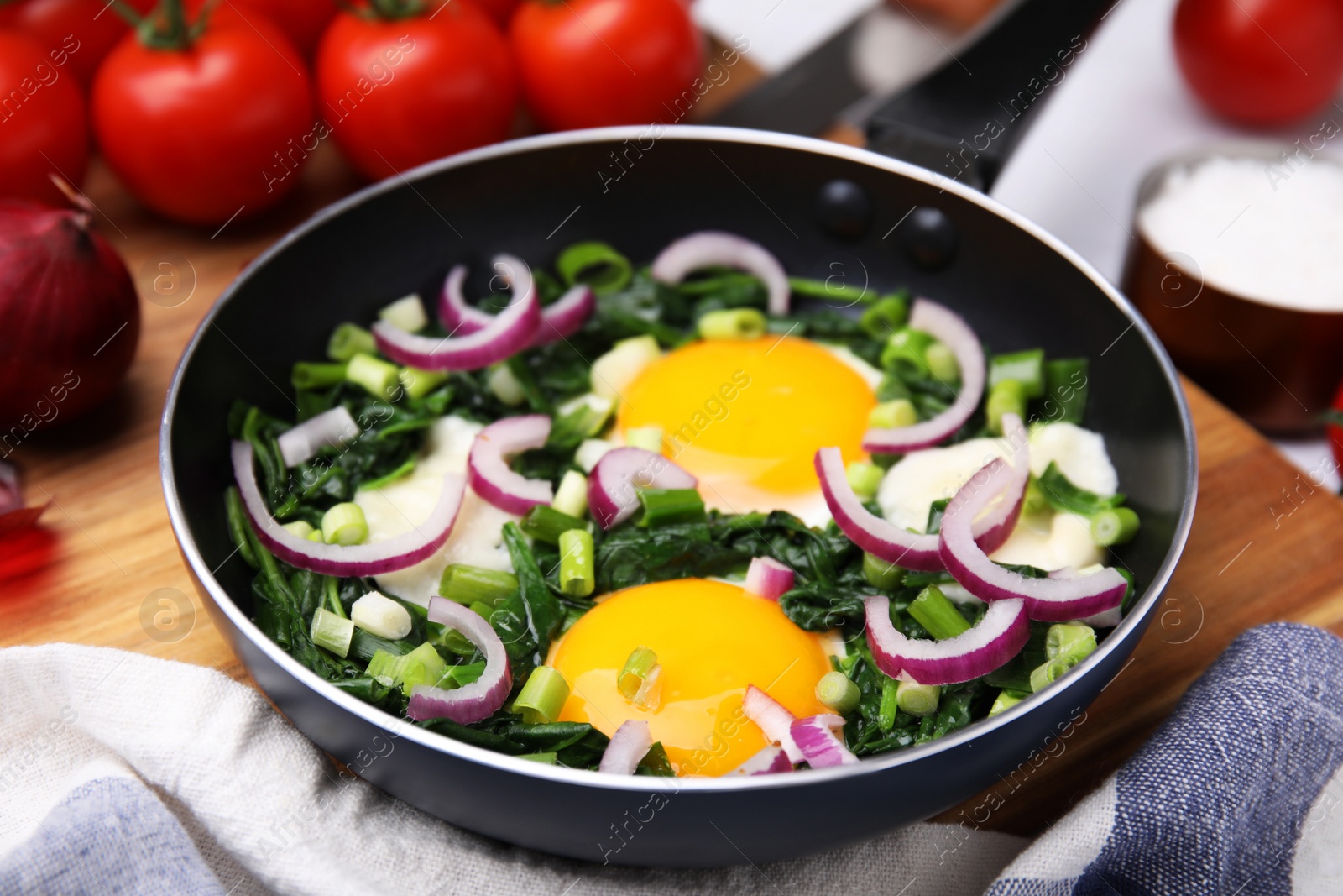 Photo of Tasty green Shakshouka served on table, closeup