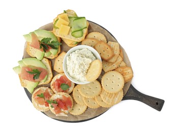 Different snacks with salted crackers on white background, top view