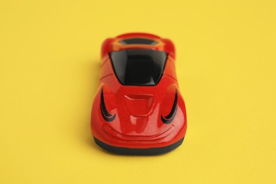 Photo of One red car on yellow background. Children`s toy