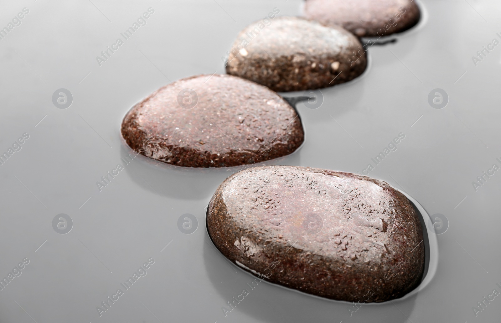 Photo of Wet stones in water, closeup. Zen lifestyle