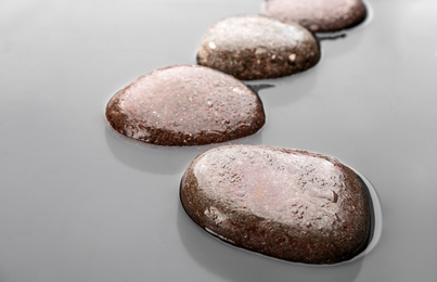 Photo of Wet stones in water, closeup. Zen lifestyle