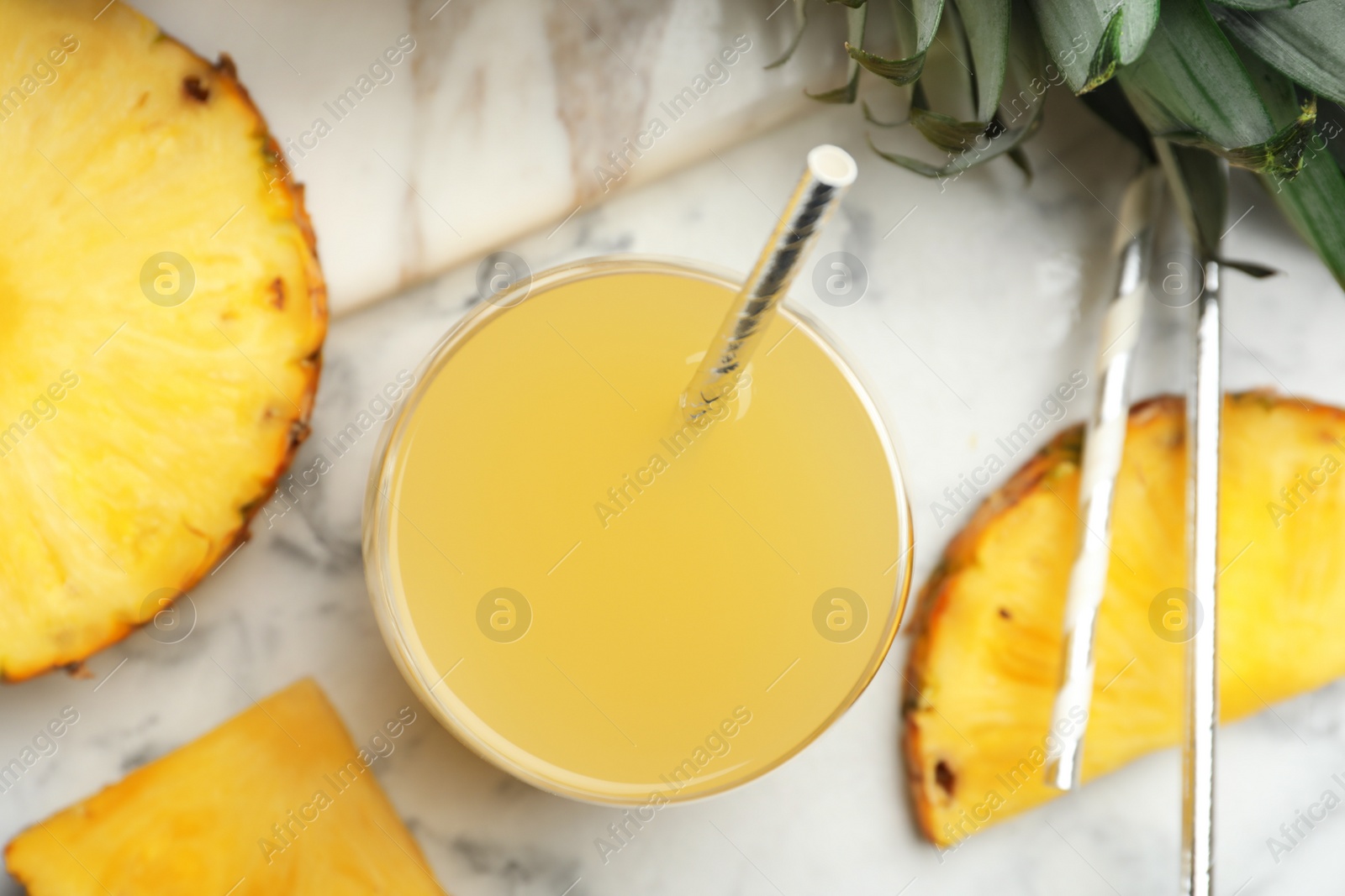 Photo of Delicious pineapple juice and fresh fruit on white marble table, top view