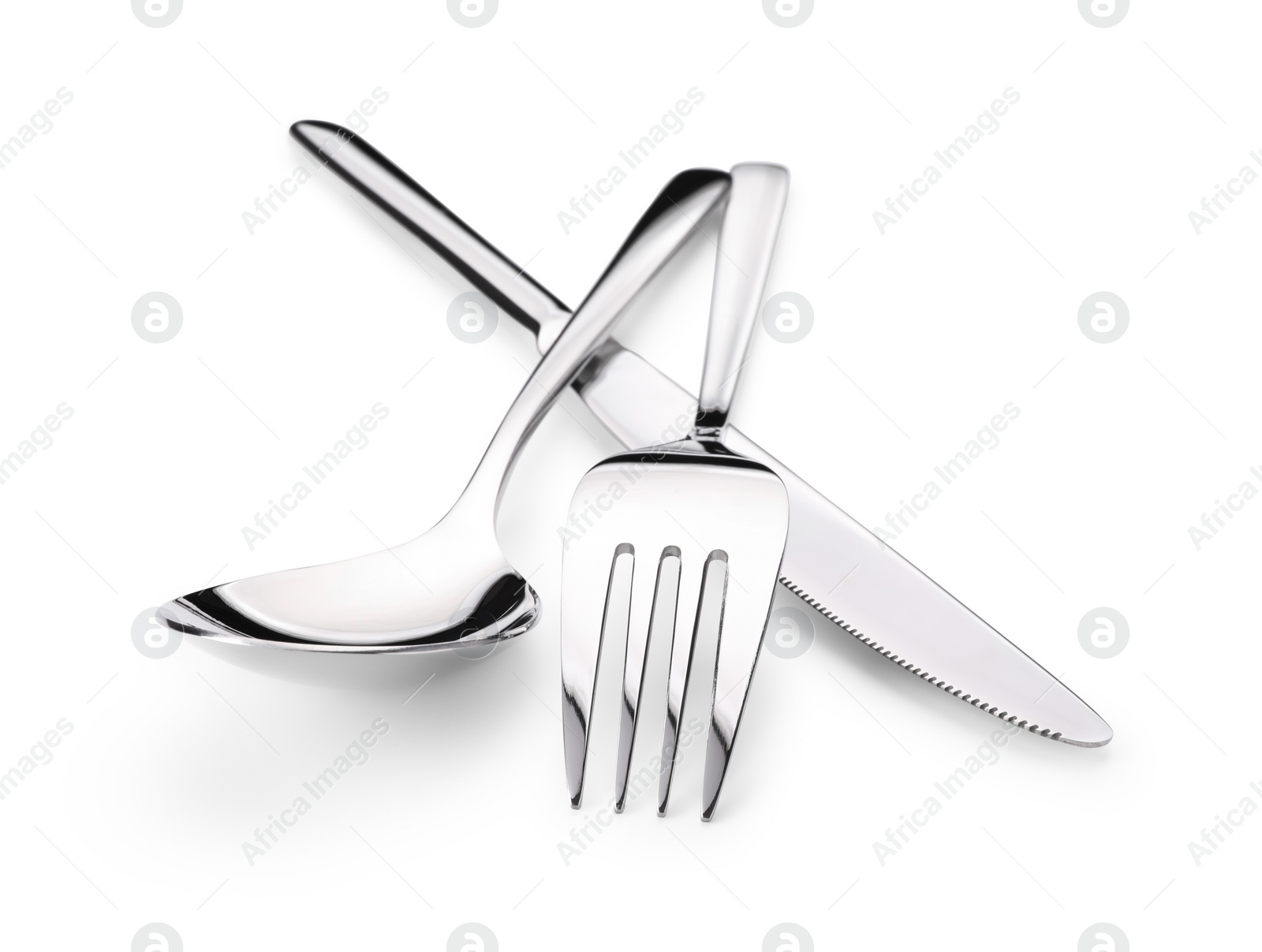 Photo of Shiny silver fork, knife and spoon isolated on white. Luxury cutlery set