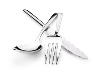 Photo of Shiny silver fork, knife and spoon isolated on white. Luxury cutlery set